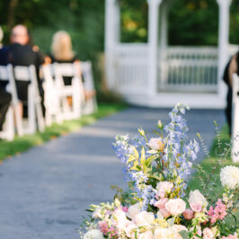 Ground aisle flowers in pastel colors. Photo by Rachel Dampolo